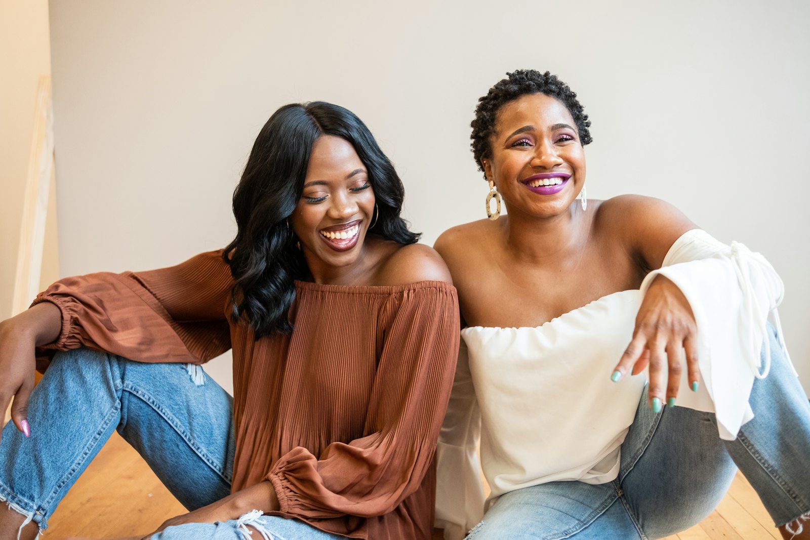 Two women sitting together and smiling